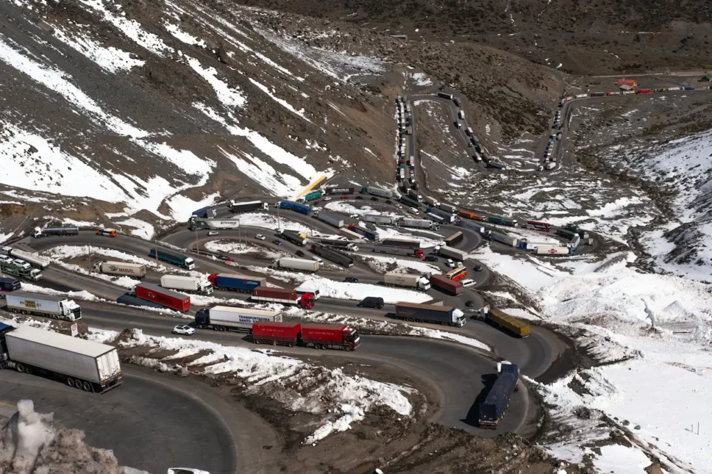 Lots Of Trucks Going Down a Steep Winding Road